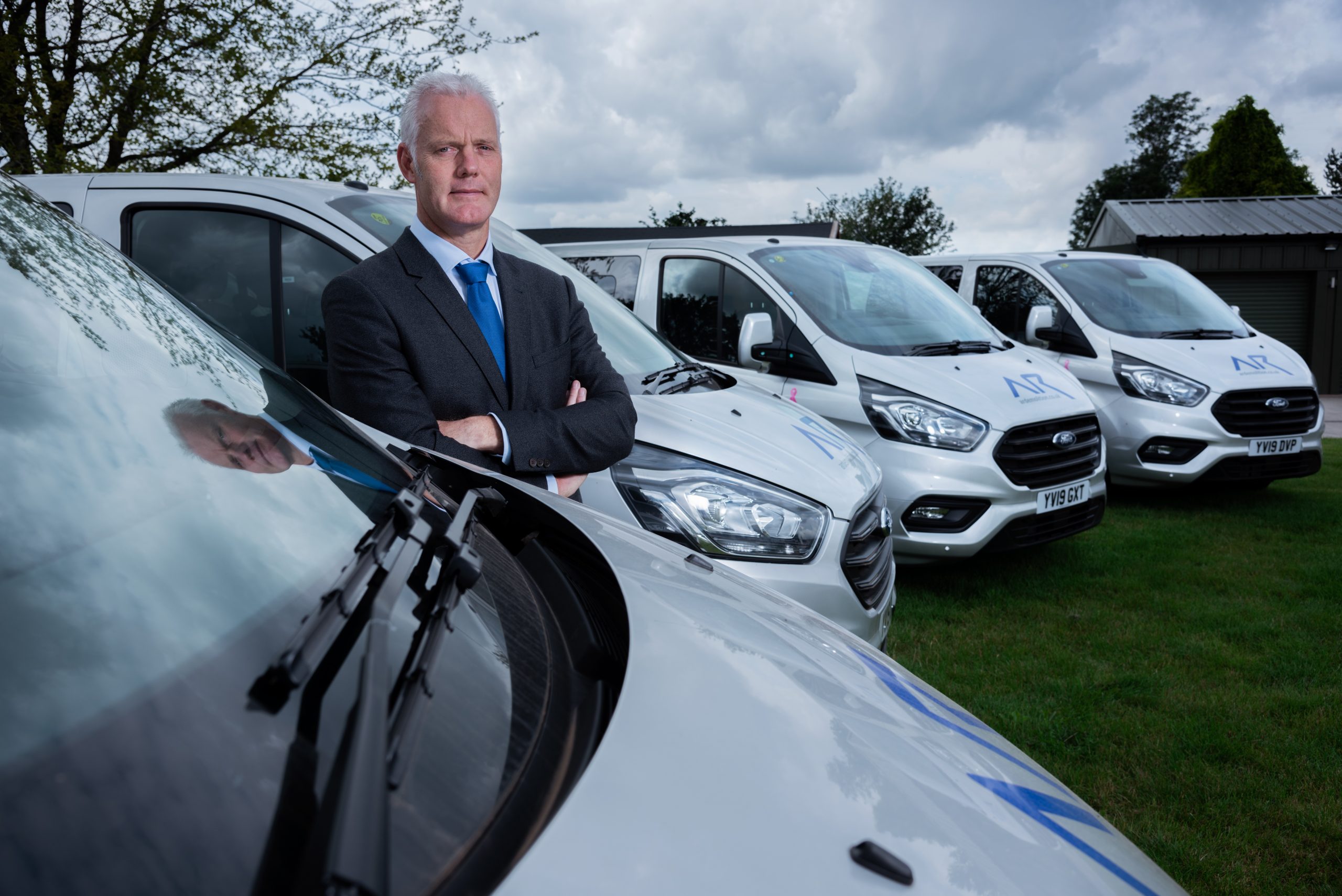 https://www.turnthetablespr.com/app/uploads/2020/05/Richard-Dolman-of-AR-Demolition-with-some-of-the-fleet-of-new-company-vans-scaled.jpg